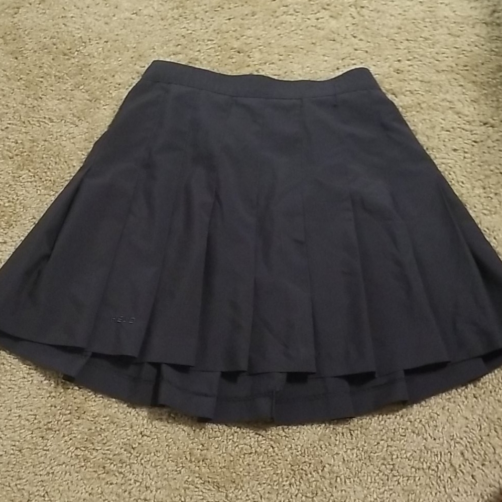 Head tennis pleated skirt elastic waist. Dry fit.